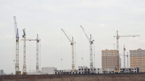 High cranes working on building sites. timelapse. many construction cranes Stock Footage 120577049