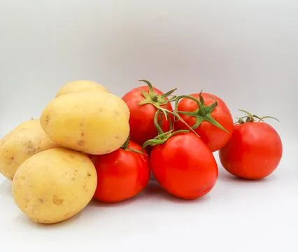 A high-definition studio photograph capturing a neat cluster of four vine-ripene Stock Photos