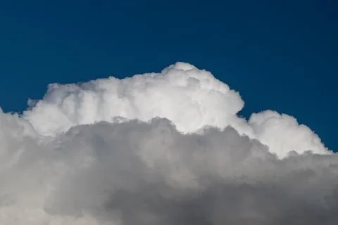 High detail cloud texture against deep blue, visible grain, layered shadows.. Stock Photos