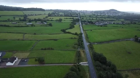 High Drone Coming into Castlewellan looking at the road Stock Footage 317541691