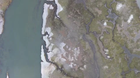 A High Up Drone Glides Over Marsh Estuary In Winter With Snow At Sunrise Stock Footage 301091931