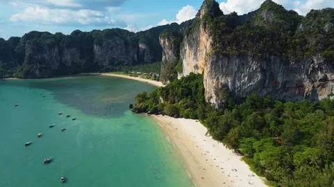 High Drone Over Railay Beach Toward Limestone Cliff With Orange Tones Stock Footage 331145063