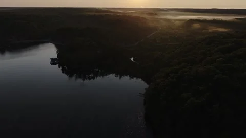 High Drone Pulling Back Over Muskoka Forest and Lake at Sunset Video stock 346648982