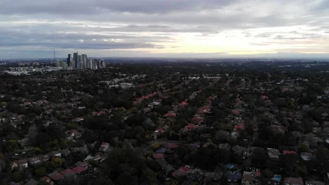 A high drone shot of many gridded houses and tall buildings in the background Stock Footage 136332186