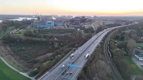 High drone view between motorway and rail at sunrise Stock Footage 331189393