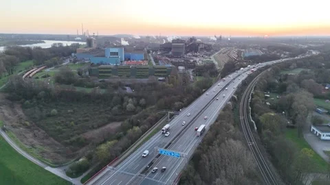 High drone view between motorway and rail at sunrise Stock Footage 332627908