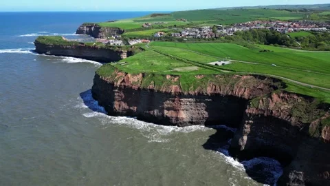 High drone view of north yorkshire coastline showing tall cliffs and Video stock 243003696