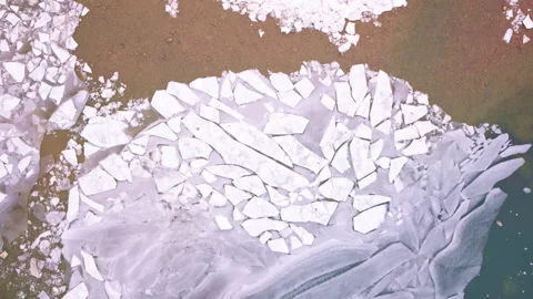 High drone view of northern Michigan's frozen Great Lakes showcasing intricate Stock Footage 338196152