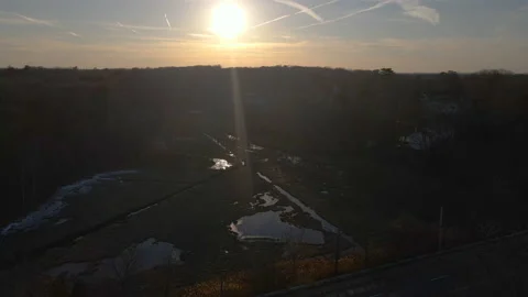 High dynamic range aerial shot of drone pulling back from marshes to Stock Footage 150575039