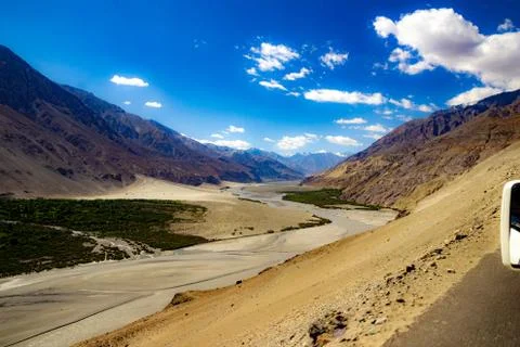 High dynamic range image of barren mountain in a desert with river and deep b Stock Photos