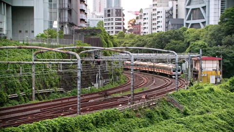 High efficiency Japanese train system with quad track local and express service  動画素材 244052376