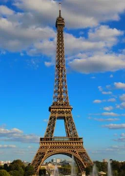 High eiffel tower with very bright colors and white clouds in the blue sky in Fotos Stock