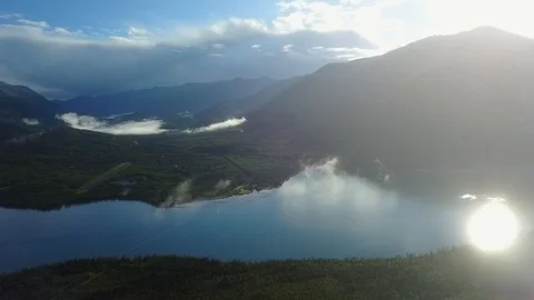High elevation drone shot over lake with mountains in background Stock Footage 115509451
