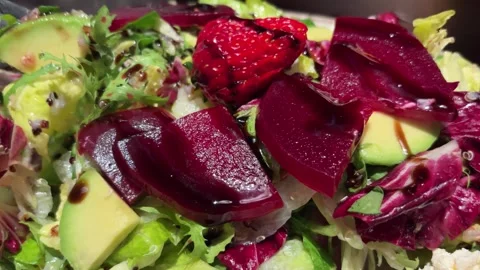 High-End Beet Salad with Avocado, Strawberry, Cheese, and Fork Taking a Bite Stock Footage 332749332