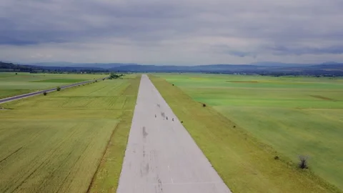 High end biker in action training on an abandoned former air-strip Stock Footage 133044889