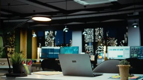 High end empty office features laptop and monitors for forecasting Stock Photos