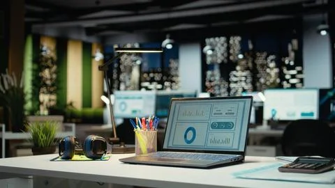 High end empty workspace features laptop with data charts for forecasting Stock Photos