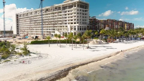 A high end hotel construction site next to the beach in Cancun, Mexico at sunset Stock Footage 104146664