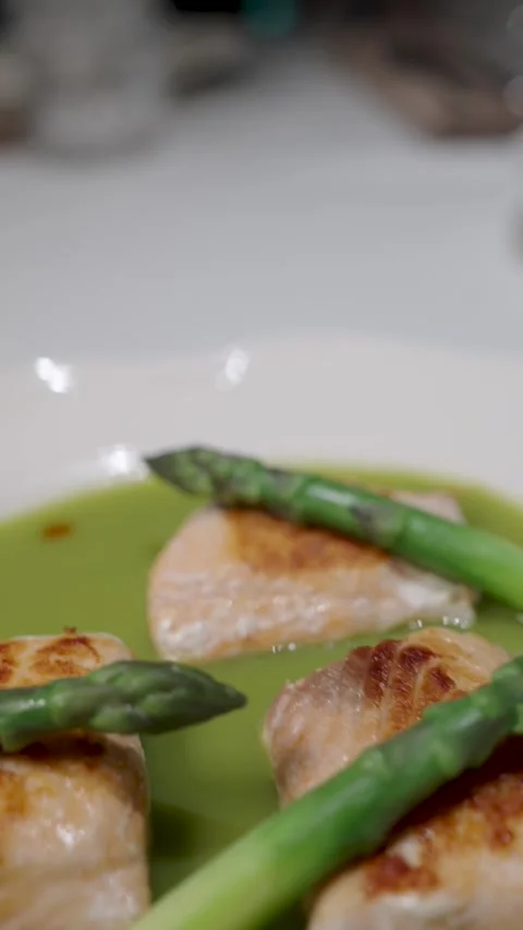 High end restaurant dish featuring three pieces of pan seared fish fillets .. Stock Footage 333915186
