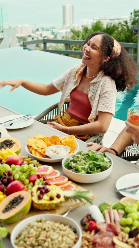 High five, funny and people with food, swimming pool for vacation and happiness Stock Footage 332906192