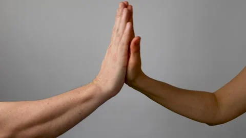 High five gesture on a gray background Stock Footage 238355192