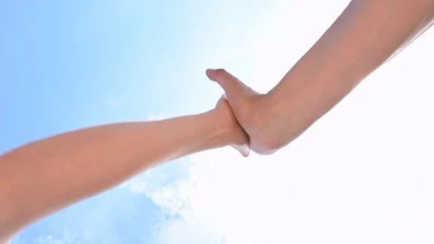 High five handshake, closeup two hands takes each other sky background Vidéo 107680541