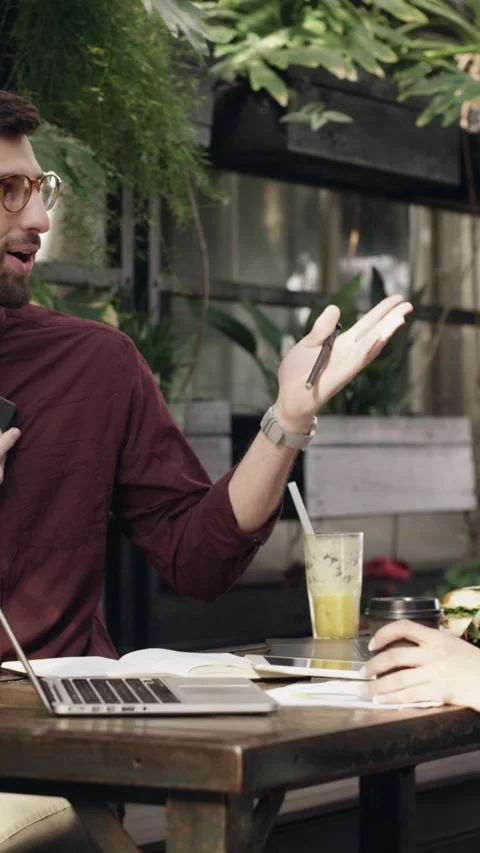 High five, phone call and remote work with people in coffee shop for small Stock Footage 329856578
