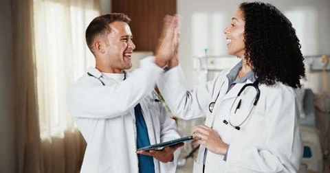 High five, smile and tablet with doctors in hospital together for goals, success Stock Photos
