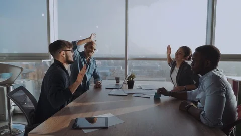 High-five for success! Cheerful professionals Stock Footage 99198212