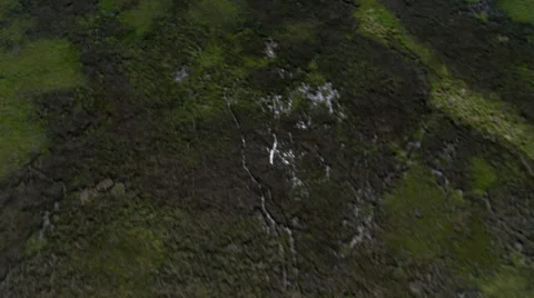 High flight over grassy swampland, sunlight flashing on water Stock Footage 59334622