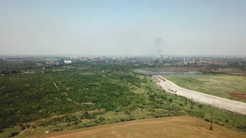 High flight over a wheat field near a plant that pollutes ecology with smoke Stock Footage 196382662