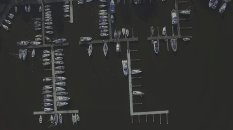 A high fly-over looking straight down at a small marina on a european lake Video stock 63920275