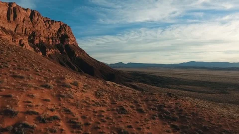 High flying desert drone heading towards red mountains Stock Footage 123003135