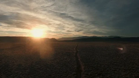 High flying drone heading into the beautiful desert sunset Stock Footage 123003554