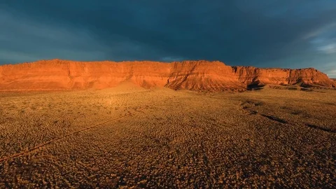 High flying drone heading towards beautiful red mountains in the desert Stock Footage 123003624
