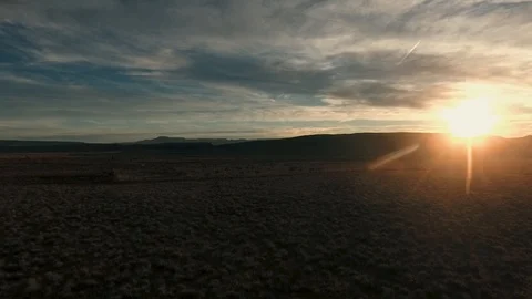 High flying drone making a turn into the desert sunset Stock Footage 123003607