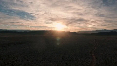 High flying drone sinking into sunset in the desert Stock Footage 123003651