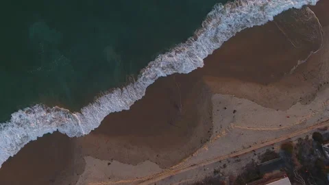 High Flyover of Rolling Waves Crashing at Sunset in Crystal Cove Stock Footage 157190778