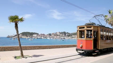 A high frame rate clip of a tram approaching at a seaside town on mallorca Stock Footage 260883197