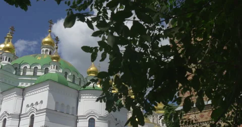 A High Green Tree With Swinging Branches and Ancient Building of Uspansky Sobor Stock Footage 52921106