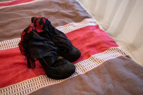 High heels and Stockings on the ceiling of a bed Stock Photos