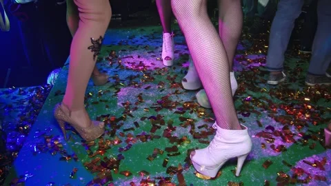 High heels dancing on confetti floor at a lively club night Stock Footage 311894548