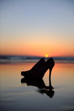 High heels on the evening beach Stock Photos
