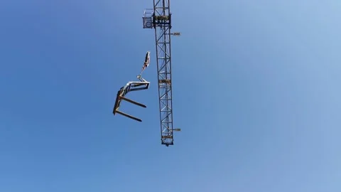 High Industrial Tower Crane Moving the Fork at Building Site Stock Footage 131552697