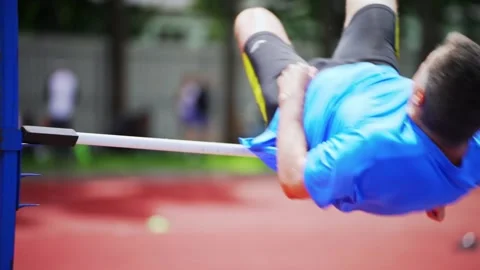 High jump athlete. An elderly man in a high jump competition. Active senior man Video stock 166841077