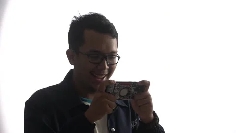 High key video of cheerful young man with glasses playing a game Stock Footage 162939294
