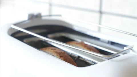 High-key video of putting toast into toaster Stock Footage 233445215
