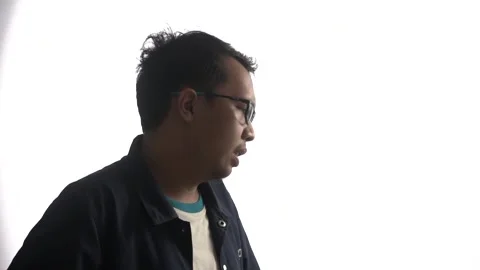 High key video of stressed young man in glasses while stroking head Stock Footage 162940664