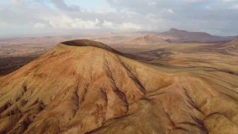 High level clip of the volcanic mountain Montana Roja Fuerteventura Stock Footage 196986734