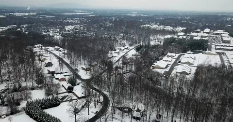 High Level Fly Over of Snow Covered Town Stock Footage